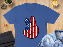 Load image into Gallery viewer, Blue t-shirt with a peace sign made of American flag pattern.
