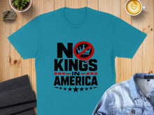 Load image into Gallery viewer, Teal t-shirt with "No Kings In America" text and crown graphic.
