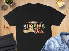 Load image into Gallery viewer, Black t-shirt with colorful text reading "Nursing is in my DNA".
