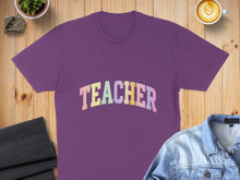 Load image into Gallery viewer, Purple t-shirt with "TEACHER" in pastel block letters across the chest.

