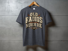 Load image into Gallery viewer, Dark grey t-shirt with text "OLD RADIOS NEVER DIE" and a knob graphic.
