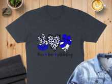 Load image into Gallery viewer, Dark t-shirt with peace sign, heart, and syringe graphics saying "Peace love phlebotomy".
