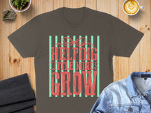 Load image into Gallery viewer, T-shirt with "HELPING LITTLE MINDS GROW" text and green stripes.
