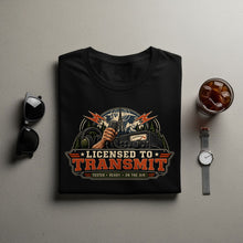 Load image into Gallery viewer, Black t-shirt with "Licensed to Transmit" graphic featuring radio equipment and mountains.

