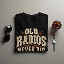 Load image into Gallery viewer, Black t-shirt with "Old Radios Never Die" text graphic.

