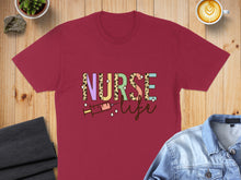 Load image into Gallery viewer, Maroon t-shirt with "Nurse Life" text and colorful syringe graphic.
