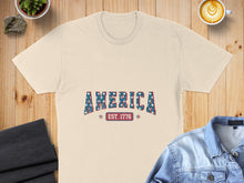 Load image into Gallery viewer, Cream t-shirt with "AMERICA EST. 1776" printed in stars and stripes.
