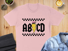 Load image into Gallery viewer, Pink t-shirt with black and yellow "ABCD" lightning bolt graphic.
