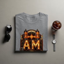 Load image into Gallery viewer, Grey t-shirt with "AM" graphic featuring vintage vacuum tubes and a microphone.
