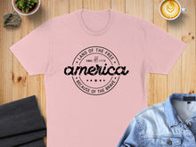 Load image into Gallery viewer, Pink t-shirt with "Land of the Free, Since 1776, Because of the Brave" text.
