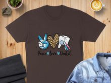 Load image into Gallery viewer, Brown t-shirt with peace sign, leopard heart, and tooth with dental tools.
