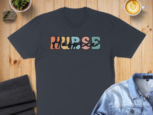Load image into Gallery viewer, Dark t-shirt with colorful "Nurse" text in retro font.
