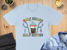 Load image into Gallery viewer, Light blue t-shirt with "Half Nurse Half Coffee" text and medical icons.
