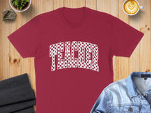 Load image into Gallery viewer, Maroon t-shirt with "TEACHER" in a checkered pattern.
