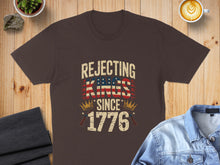 Load image into Gallery viewer, Brown t-shirt with "Rejecting Kings Since 1776" text and flag design.
