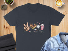 Load image into Gallery viewer, Dark t-shirt with "Peace Love Nursing" text, heart, stethoscope, and coffee cup design.
