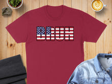 Load image into Gallery viewer, Maroon t-shirt with "BRUH" text in American flag design.
