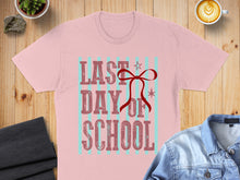 Load image into Gallery viewer, Pink t-shirt with "LAST DAY OF SCHOOL" text and a red bow.
