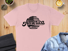 Load image into Gallery viewer, Pink t-shirt with "America EST. 1776" text and American flag graphic.
