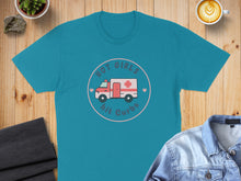 Load image into Gallery viewer, Teal t-shirt with "Hot Girls Hit Curbs" graphic featuring an ambulance.
