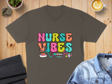Load image into Gallery viewer, Nurse Vibes graphic with stethoscope, syringe, and pill bottle on t-shirt.
