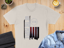 Load image into Gallery viewer, T-shirt with distressed American flag and "WE THE PEOPLE" text.
