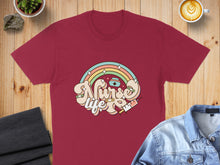 Load image into Gallery viewer, Burgundy t-shirt with "Nurse Life" text, rainbow, and syringe graphic.
