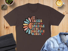 Load image into Gallery viewer, Brown t-shirt with floral "It takes a lot of sparkle to be a hospice nurse" design.
