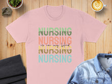 Load image into Gallery viewer, Pink t-shirt with "Nursing is in my blood" text in colorful leopard print.
