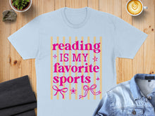 Load image into Gallery viewer, Light blue t-shirt with pink text "Reading is my favorite sports" and bows.
