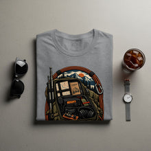 Load image into Gallery viewer, Grey t-shirt with a graphic of an open backpack containing radio gear and a logbook.

