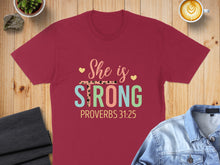 Load image into Gallery viewer, Maroon t-shirt with "She is STRONG PROVERBS 31:25" graphic.
