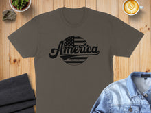Load image into Gallery viewer, Brown t-shirt with black "America Est. 1776" text and American flag circle.
