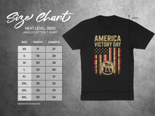 Load image into Gallery viewer, Next Level 3600 t-shirt size chart with measurements and "America Victory Day" graphic.
