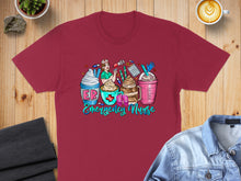 Load image into Gallery viewer, Maroon t-shirt with "Emergency Nurse" text and four stylized coffee drinks.
