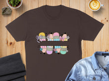 Load image into Gallery viewer, Brown t-shirt with pastel pencil graphics and floral accents.
