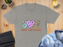 Load image into Gallery viewer, Gray t-shirt with "Peace Love Nursing" text and icons of a peace sign, heart, and stethoscope.

