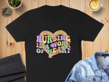 Load image into Gallery viewer, Black t-shirt with colorful "NURSING IS A WORK OF HEART" text and flowers.
