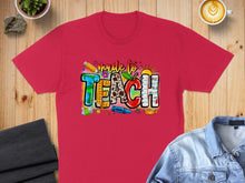 Load image into Gallery viewer, Red t-shirt with "Made to Teach" in colorful classroom-themed letters.
