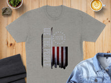 Load image into Gallery viewer, Grey t-shirt with "We the People" and a distressed American flag.
