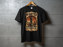 Load image into Gallery viewer, Black t-shirt with "Wanted A Clear Frequency" graphic featuring a microphone and desert scene.
