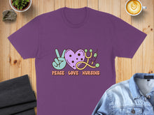 Load image into Gallery viewer, Purple t-shirt with "Peace Love Nursing" text, heart, stethoscope, and syringe graphic.
