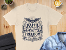 Load image into Gallery viewer, Cream t-shirt with "Faith and Family and Freedom 1776-2026" emblem.
