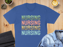 Load image into Gallery viewer, Blue t-shirt with stacked "NURSING IS MY JAM" text in colorful block letters.
