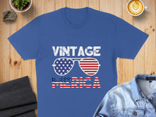 Load image into Gallery viewer, Blue t-shirt with "VINTAGE AMERICA" text and American flag sunglasses.
