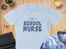 Load image into Gallery viewer, Light blue t-shirt with "School Nurse" text and a band-aid graphic.
