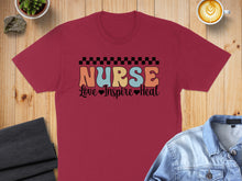 Load image into Gallery viewer, Burgundy t-shirt with "Nurse" in colorful retro font, "Love Inspire Heal" below.
