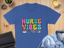 Load image into Gallery viewer, Blue t-shirt with colorful "Nurse Vibes" text and medical icons.

