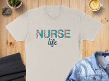 Load image into Gallery viewer, Cream t-shirt with "Nurse Life" text in leopard print and blue letters.
