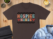 Load image into Gallery viewer, Brown t-shirt with "Hospice Nurse" text, checkerboard, and heartbeats.
